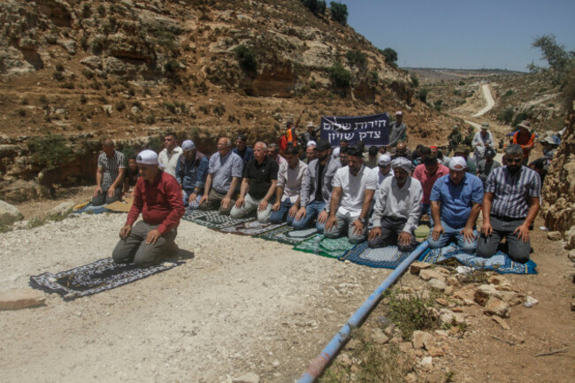 july-14-2023-salfit-west-bank-palestine-palestinian-protesters-pray-in-front-of-the-israeli-army-forces-during-a-demonstration-against-the-illegal-establishment-of-jewish-settlements-on-palestini