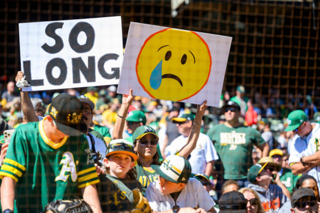 oakland-ca-september-26-oakland-athletics-fans-hold-up-their-signs-before-an-mlb-game-between-the-texas-rangers-and-oakland-athletics-on-september-26-2024-at-the-oakland-alameda-county-coliseum