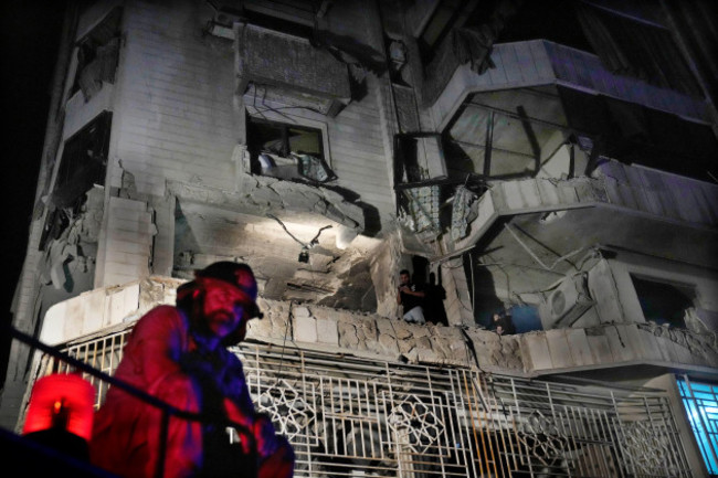 a-firefighter-stands-in-front-of-an-apartment-hit-by-an-israeli-airstrike-in-beirut-lebanon-thursday-oct-3-2024-ap-photohussein-malla