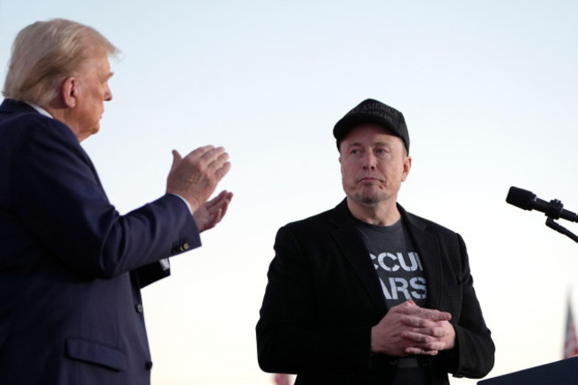 republican-presidential-nominee-former-president-donald-trump-left-claps-as-tesla-and-spacex-ceo-elon-musk-prepares-to-depart-after-speaking-at-a-campaign-event-at-the-butler-farm-show-saturday-oc