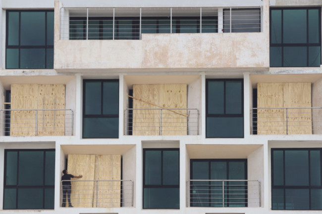 a-man-boards-up-an-apartment-building-to-protect-it-from-hurricane-milton-in-progreso-yucatan-state-mexico-monday-oct-7-2024-ap-photomartin-zetina