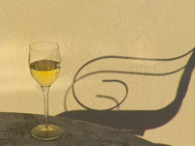 white-wine-sunset-vacation-alfresco-chair-relax-white-wine-glass-on-sunny-alfresco-terrace-table-with-shadow-of-outdoor-lounger-chair-at-sunset