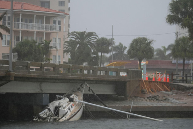 a-boat-damaged-in-hurricane-helene-rests-against-a-bridge-ahead-of-the-arrival-of-hurricane-milton-in-south-pasadena-fla-wednesday-oct-9-2024-ap-photorebecca-blackwell