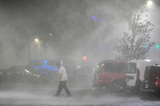 max-watts-of-buford-ga-walks-in-the-parking-lot-to-check-on-a-trailer-parked-outside-the-hotel-where-he-is-riding-out-hurricane-milton-with-coworkers-wednesday-oct-9-2024-in-tampa-fla-watts