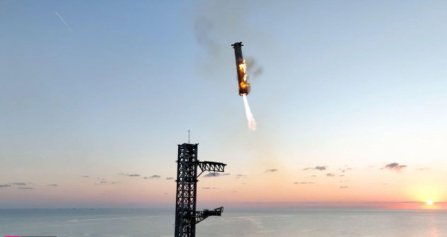 this-image-provided-by-spacex-shows-spacexs-mega-rocket-booster-returning-to-the-launch-pad-to-be-captured-during-a-test-flight-sunday-oct-13-2024-in-boca-chica-texas-spacex-via-ap