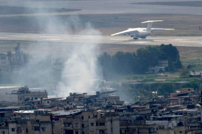 a-plane-take-off-from-rafik-hariri-international-airport-as-smoke-of-a-past-israeli-airstrike-still-rise-from-dahiyeh-in-beirut-lebanon-monday-oct-14-2024-ap-photohussein-malla