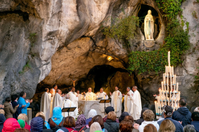 praying-at-a-morning-mass-or-service-grotte-de-massabielle-grotto-of-massabielle-sanctuary-of-our-lady-of-lourdes-lourdes-pyrenees-france