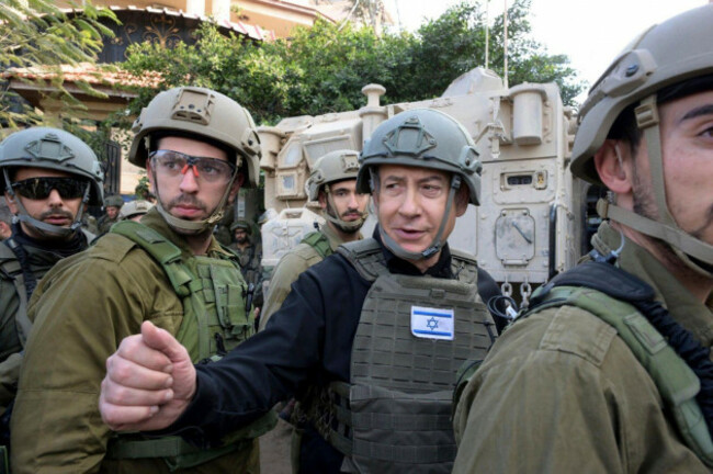 file-israeli-prime-minister-benjamin-netanyahu-center-wears-a-protective-vest-and-helmet-as-he-receives-a-security-briefing-with-commanders-and-soldiers-in-the-northern-gaza-strip-on-monday-dec