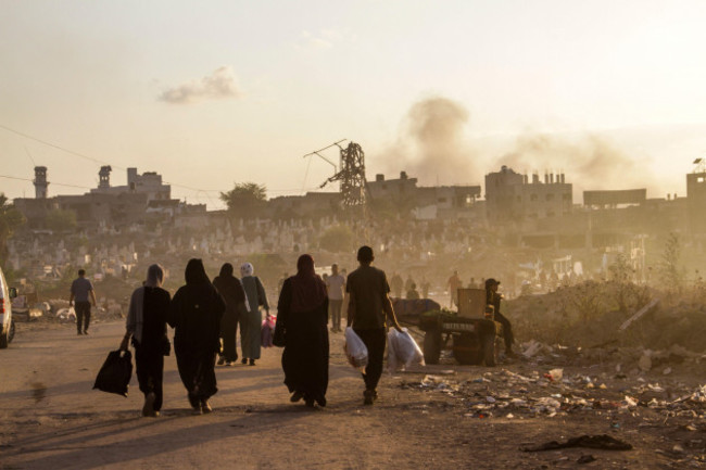 october-17-2024-gaza-city-the-gaza-strip-palestine-palestinians-walk-in-a-street-bombed-by-the-israeli-army-as-smoke-rises-in-gaza-city-credit-image-mahmoud-issaquds-net-news-via-zuma