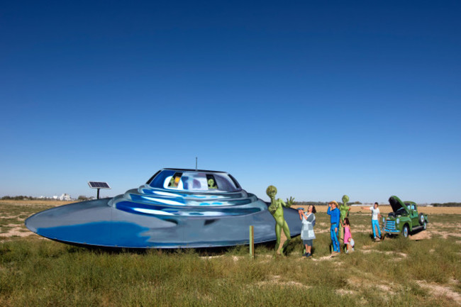 roadside-display-depicting-a-ufo-aliens-and-local-people-welcoming-them-outside-of-roswell-new-mexico