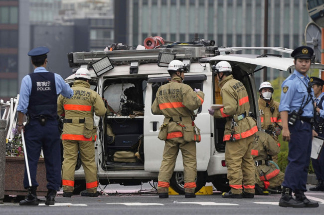 officials-work-near-a-vehicle-which-was-stuck-against-a-security-fence-near-the-prime-ministers-office-in-tokyo-saturday-oct-19-2024-kyodo-news-via-ap