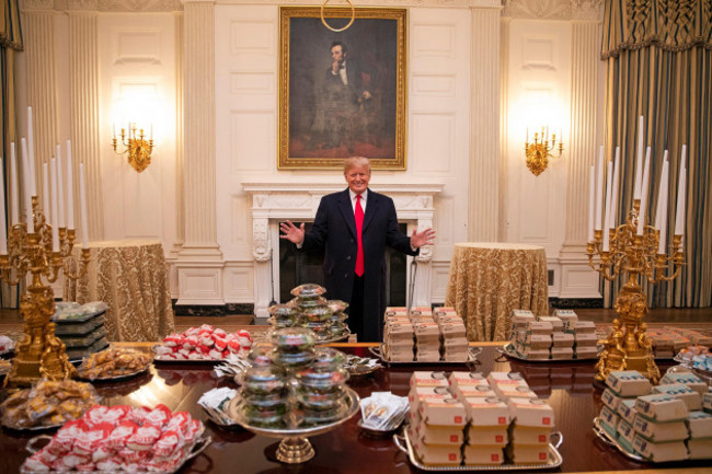 u-s-president-donald-trump-stands-behind-a-spread-of-fast-food-that-he-purchased-for-the-celebration-for-the-2018-ncaa-college-football-national-champion-clemson-tigers-in-the-state-dining-room-of-the