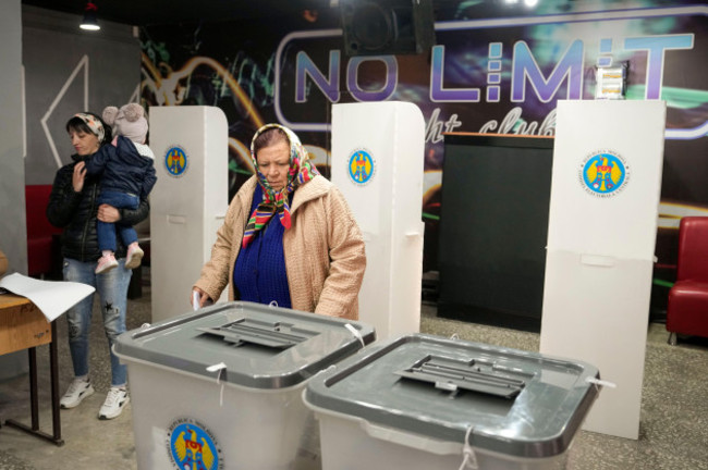 a-woman-prepares-to-cast-her-vote-in-hrusevo-moldova-sunday-oct-20-2024-during-a-presidential-election-and-a-referendum-on-whether-to-enshrine-in-the-constitution-the-countrys-path-to-european