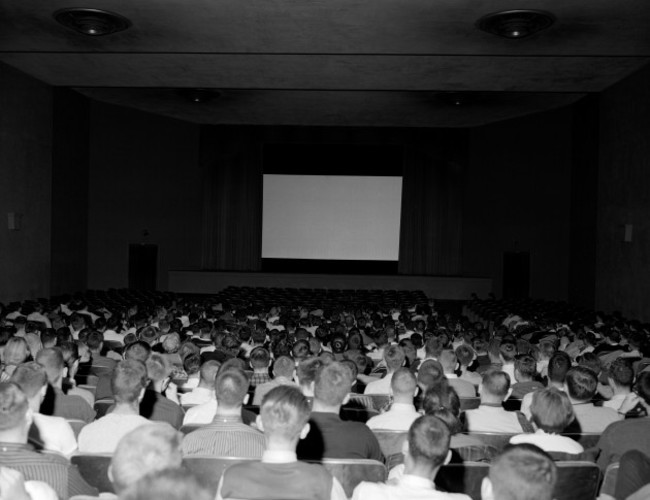 rear-view-of-a-group-of-people-watching-a-movie-in-a-movie-theater