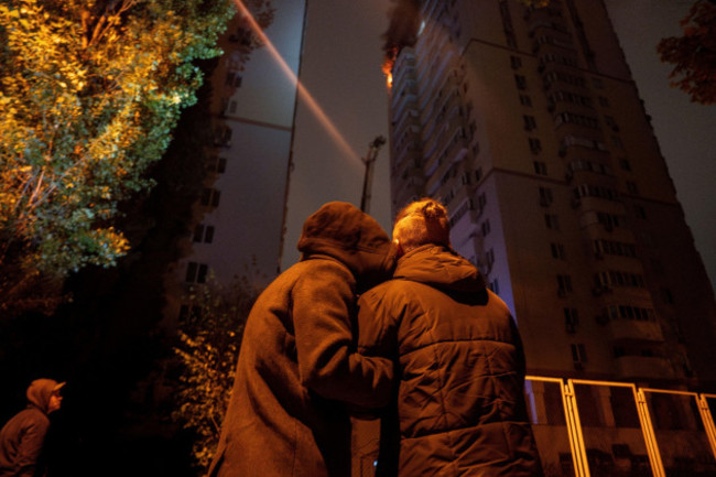 a-couple-comforts-each-other-while-watching-a-fire-in-a-residential-building-after-russian-drones-killed-a-teenager-in-kyiv-ukraine-friday-oct-25-2024-ap-photoalex-babenko