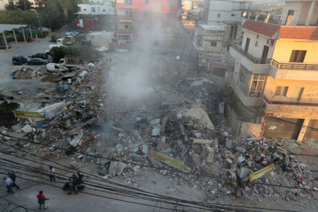 people-gather-next-to-a-destroyed-building-hit-in-an-israeli-airstrike-in-tyre-lebanon-monday-oct-28-2024-ap-photomohammed-zaatari