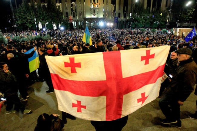 a-protester-holds-georgian-flag-during-an-opposition-protest-against-the-results-of-the-parliamentary-election-in-tbilisi-georgia-monday-oct-28-2024-ap-photoshakh-aivazov