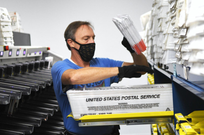 michael-duve-places-mail-in-ballots-into-trays-in-the-sorting-room-at-the-orange-county-supervisor-of-elections-office-on-october-26-2020-in-orlando-florida-with-nine-days-until-the-november-3-elec