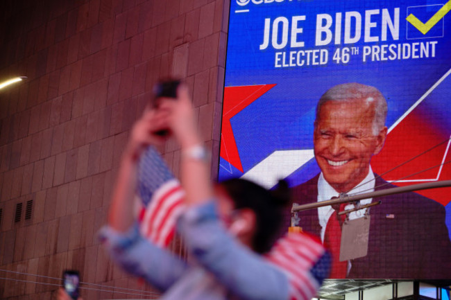 people-watch-the-abc-good-morning-america-gma-studios-videoscreen-as-president-elect-joe-biden-gives-his-acceptance-speech-from-delaware-in-times-square-new-york-on-november-7-2020-democrat-joe