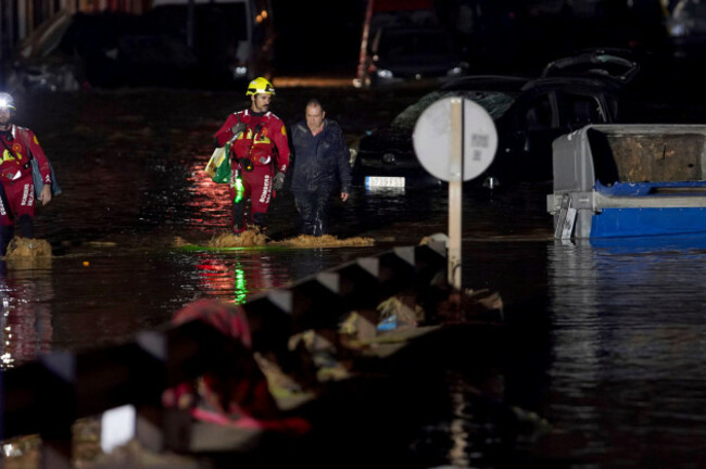 residents-accompanied-by-firefighters-walk-through-flooded-streets-in-valencia-spain-wednesday-oct-30-2024-ap-photoalberto-saiz