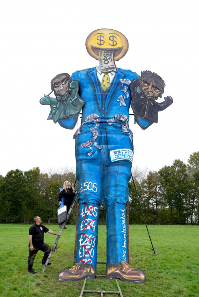 members-of-the-edenbridge-bonfire-society-reece-hook-left-and-andrea-deans-unveil-their-guy-for-2024-which-is-a-depiction-of-ticket-selling-platform-ticketmaster-featuring-noel-and-liam-gallagher