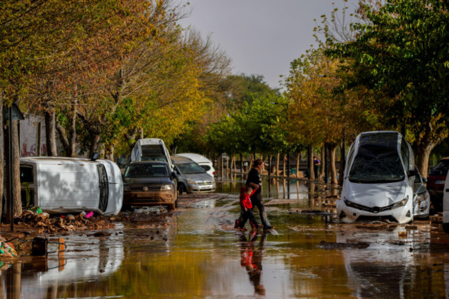 people-cross-flooded-streets-in-utiel-spain-wednesday-oct-30-2024-ap-photomanu-fernandez