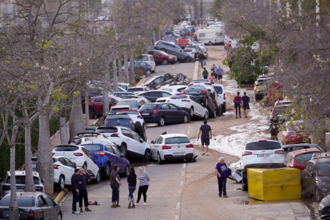 residents-walk-next-to-cars-piled-up-after-being-swept-away-by-floods-in-paiporta-near-valencia-spain-wednesday-oct-30-2024-ap-photoalberto-saiz