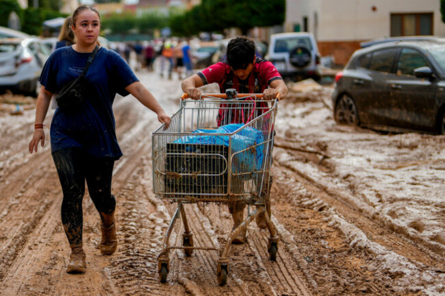 two-people-push-a-cart-loaded-with-belongings-in-valencia-spain-thursday-oct-31-2024-ap-photomanu-fernandez