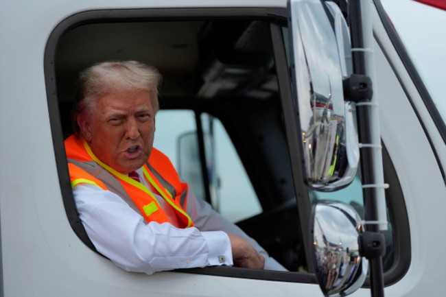 republican-presidential-nominee-former-president-donald-trump-talks-to-reporters-as-he-sits-in-a-garbage-truck-wednesday-oct-30-2024-in-green-bay-wis-ap-photojulia-demaree-nikhinson