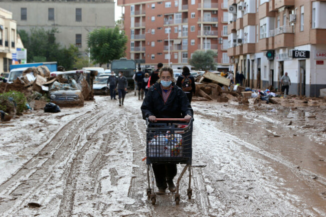 a-woman-pushes-a-supermarket-trolley-with-food-in-a-muddy-street-after-floods-in-paiporta-near-valencia-spain-sunday-nov-3-2024-ap-photohugo-torres