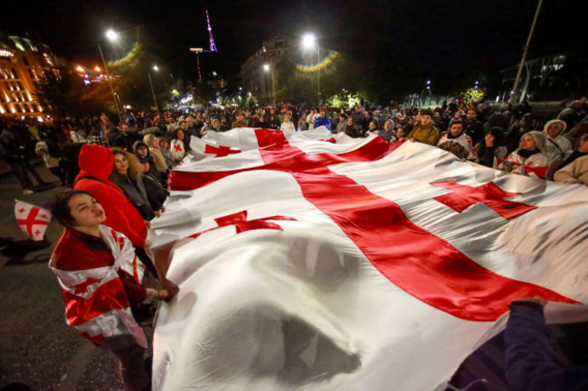 protesters-carry-a-huge-georgian-national-flag-during-a-rally-against-alleged-violations-in-a-recent-parliamentary-election-in-tbilisi-georgia-on-monday-nov-4-2024-ap-photozurab-tsertsvadze