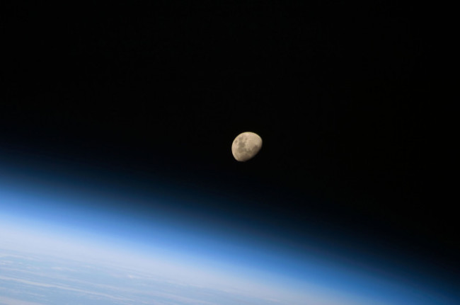 august-30-2009-a-gibbous-moon-visible-above-earths-atmosphere