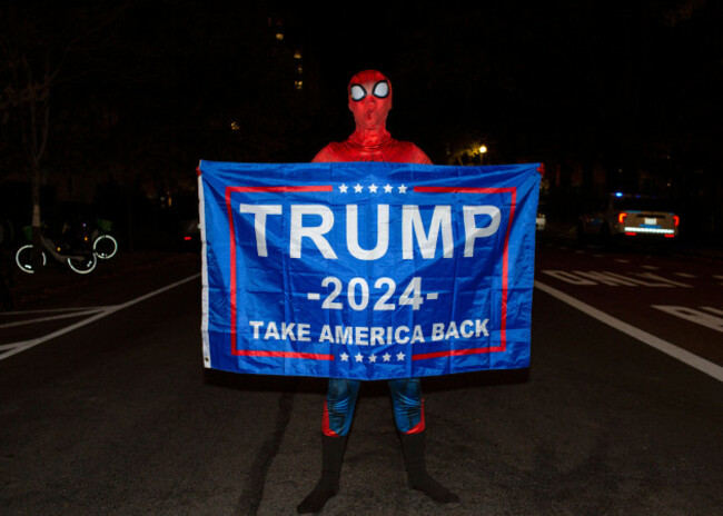 washington-usa-05th-nov-2024-a-supporter-of-republican-presidential-candidate-donald-trump-wearing-spider-mans-costume-with-a-banner-trump-2024-take-america-back-is-written-on-it-stands-on-a-road