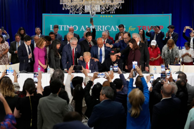 latino-leaders-pray-with-republican-presidential-nominee-former-president-donald-trump-front-center-as-he-participates-in-a-roundtable-with-latino-leaders-tuesday-oct-22-2024-in-doral-fla-ap