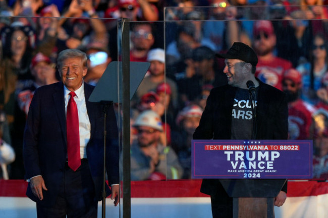 republican-presidential-nominee-former-president-donald-trump-listens-as-elon-musk-speaks-during-a-campaign-rally-at-the-butler-farm-show-saturday-oct-5-2024-in-butler-pa-ap-photojulia-demare