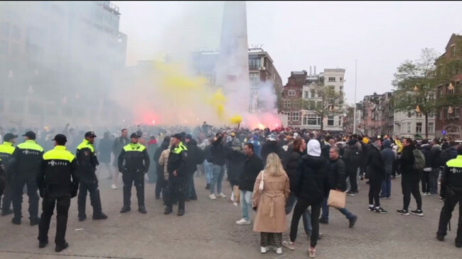 in-this-image-taken-from-video-police-stand-guard-as-maccabi-tel-aviv-supporters-light-flares-at-the-dam-square-in-amsterdam-the-netherlands-thursday-nov-7-2024-ap-photo-intervision