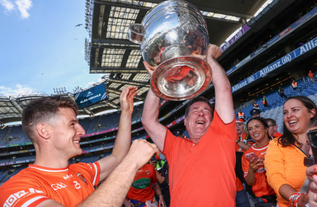 niall-grimley-sees-his-father-brian-lift-the-sam-maguire-trophy-after-the-game