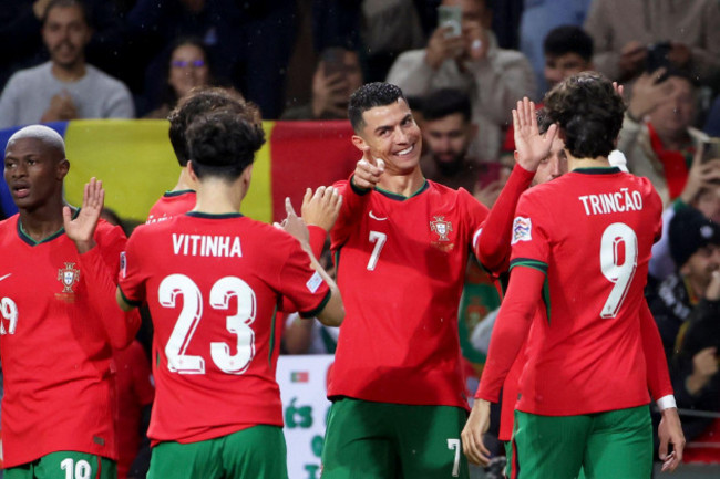 portugals-cristiano-ronaldo-center-points-at-teammates-vitinha-when-celebrating-after-scoring-his-sides-fifth-goal-during-the-uefa-nations-league-soccer-match-between-portugal-and-poland-at-the-dr