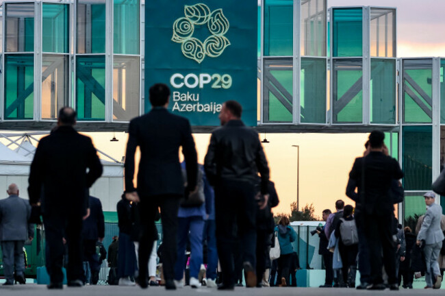 baku-azerbaijan-november-14-2024-participants-walk-in-front-of-the-main-entrance-during-united-nations-climate-change-conference-cop29-an-event-held-by-unfccc-in-baku-olympic-stadium-cop29-run