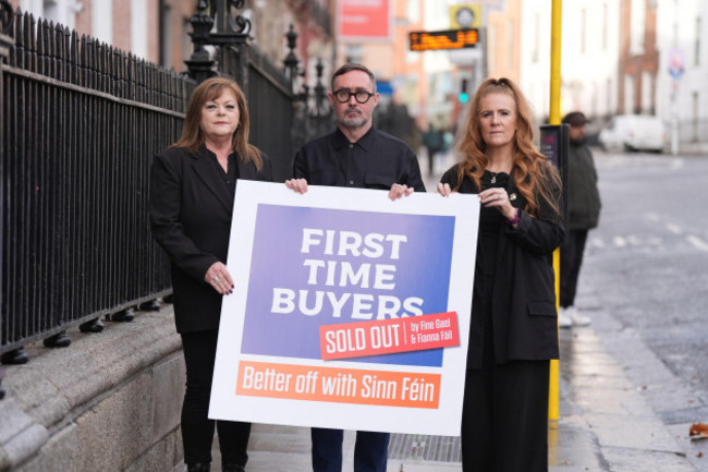 sinn-fein-representatives-councillor-ann-graves-left-eoin-obroin-and-councillor-janice-boylan-hold-up-a-banner-on-housing-outside-the-teachers-club-in-dublin-picture-date-saturday-november-23