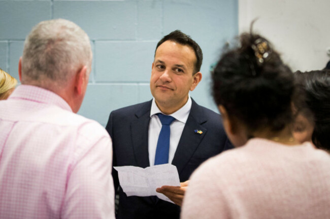 taoiseach-leo-varadkar-at-phibblestown-community-centre-in-dublin-holds-a-sheet-of-paper-with-the-breakdown-of-votes-listens-to-supporters-as-counting-continues-in-the-2020-irish-general-election-cou