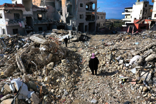 residents-walk-past-destroyed-buildings-as-they-return-to-qana-village-southern-lebanon-thursday-nov-28-2024-following-a-ceasefire-between-israel-and-hezbollah-that-went-into-effect-on-wednesday