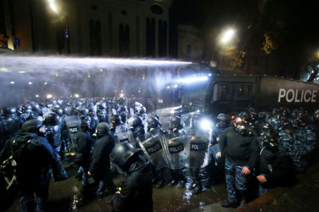 police-use-a-water-cannon-to-prevent-protesters-pouring-into-the-streets-following-georgian-prime-minister-irakli-kobakhidzes-announcement-rallying-outside-the-parliament-building-in-tbilisi-georgi