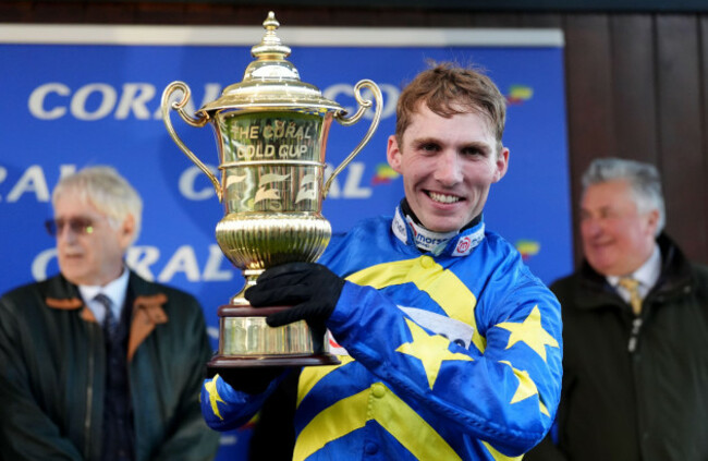 jockey-harry-cobden-with-the-trophy-after-riding-kandoo-kid-to-victory-in-the-coral-gold-cup-handicap-chase-during-the-coral-gold-cup-day-at-newbury-racecourse-picture-date-saturday-november-30-202