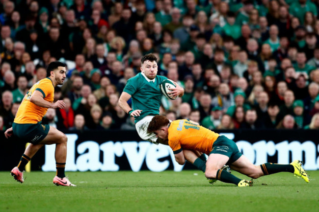 irelands-hugo-keenan-centre-is-tackled-by-australias-andrew-kellaway-right-as-teammate-tom-wright-watches-on-during-the-autumn-nations-series-rugby-union-match-between-ireland-and-australia-at