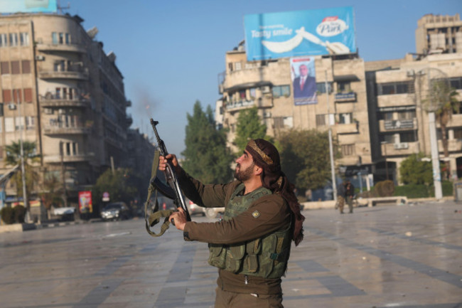 a-syrian-opposition-fighter-shoots-in-the-air-in-downtown-aleppo-syria-saturday-nov-30-2024-ap-photoghaith-alsayed