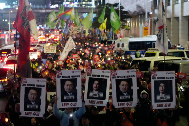 protesters-march-to-the-presidential-office-after-a-candlelight-vigil-against-south-korean-president-yoon-suk-yeol-in-seoul-south-korea-thursday-dec-5-2024-ap-photoahn-young-joon