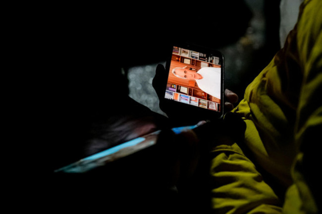 journalists-watch-on-their-mobile-phones-a-recorded-video-of-calin-georgescu-the-independent-candidate-for-presidency-who-won-the-first-round-of-presidential-elections-after-the-constitutional-court