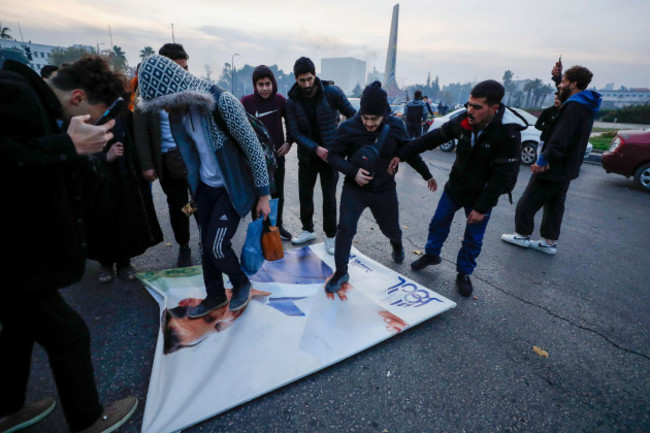 syrians-celebrate-the-arrival-of-opposition-fighters-as-they-step-on-a-picture-of-syrian-president-bashar-assad-in-damascus-syria-sunday-dec-8-2024-ap-photoomar-sanadiki