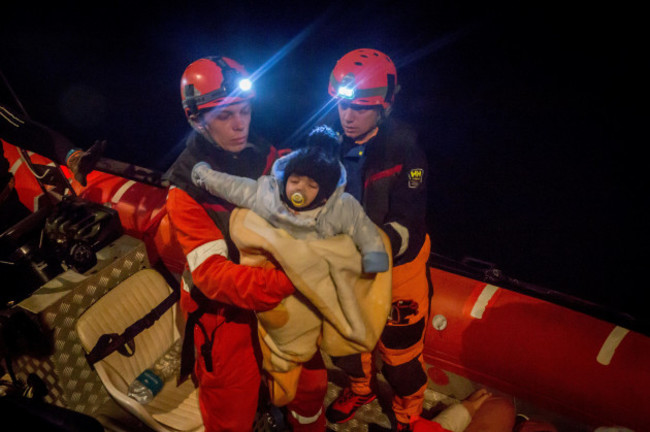 palermo-italy-27th-dec-2019-a-young-child-is-rescued-from-a-boat-with-30-people-on-board-in-the-early-hours-by-the-crew-of-the-alan-kurdi-rescue-ship-operated-by-german-charity-sea-eye-the-ship